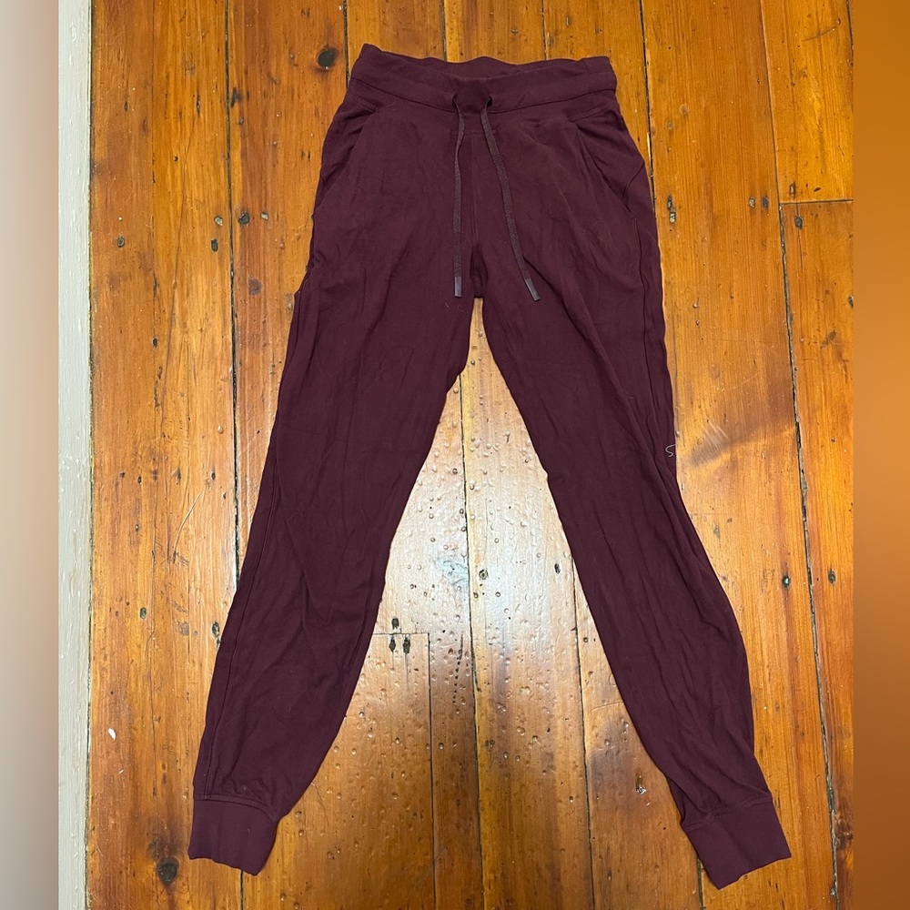 Women’s Lulu maroon joggers. One of the drawstrings is slightly damaged.